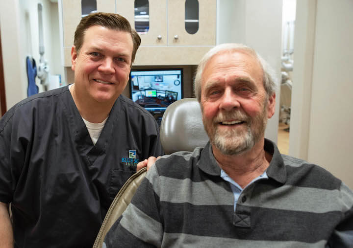 Emergency dentist in Saginaw, TX, Dr. Robinson with a patient after restoring his damaged tooth