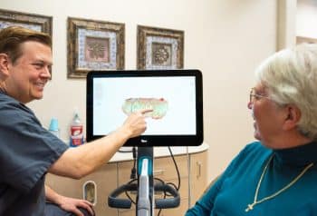 Dr. Robinson showing a patient digital impressions for same-day crowns in Saginaw, TX
