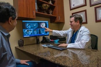 implant dentist showing patient dental implants for diabetics in saginaw, tx